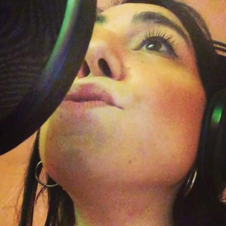 Andrea Bruno singing into a microphone